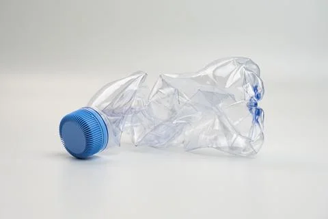 One crumpled plastic bottle isolated on white. Environmental conservation c.. Stock Photos