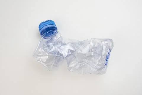 One crumpled plastic bottle isolated on white. Environmental conservation c.. Stock Photos
