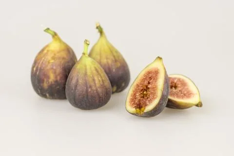 One cut fig and three whole figs Stock Photos