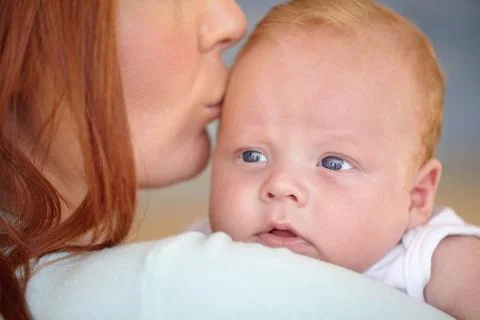 One day hell take care of her. Closeup of a baby boy being kissed on the head by Stock Photos