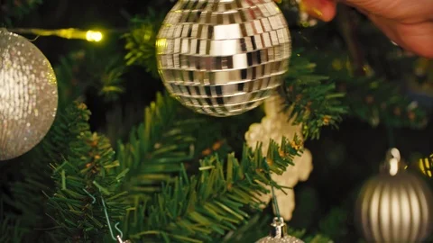 The one disco plastic ball hanging on the christmas tree decorating with light Stock Footage 99601060