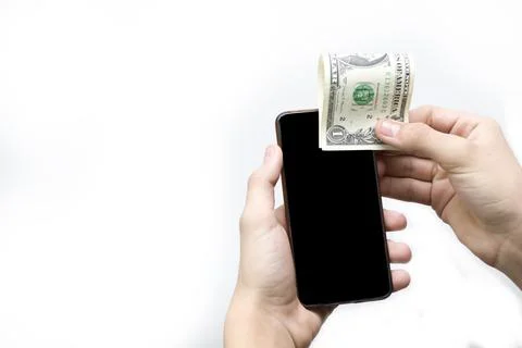 One dollar and a black phone in the hands of a teenager on a white background Stock Photos