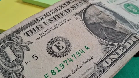 One dollar bill moving across colorful sticky notes in video motion 動画素材 339505111
