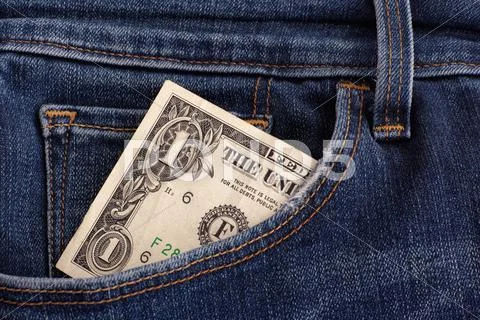 One Dollar Bill In A Pocket Of Blue Jeans