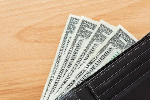 One dollar bill in wallet Stock Photos