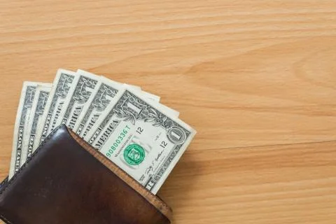 One dollar bill in wallet Stock Photos