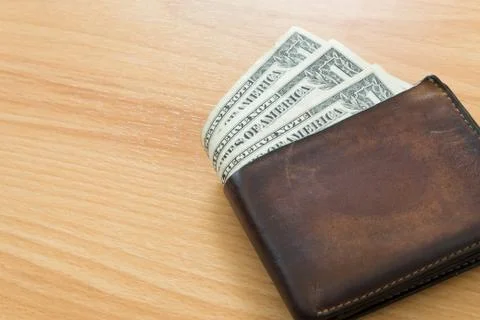 One dollar bill in wallet Stock Photos