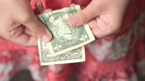One dollar in children's hands. Concept of poverty and economic problems. Stock Footage 197693195