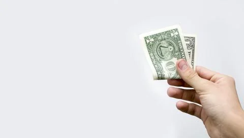 One dollar folded in half in a hand on a white background. Foto stock