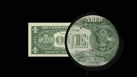One dollar note inspected closely by a magnifying glass on black background Video stock 130413877