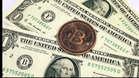 One dollars and bitcoin coin on rotating platform Stock Footage 134454589