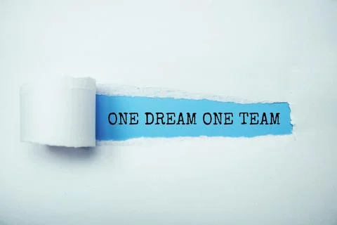 One Dream One Team message written on blue paper with torn paper background Stock Photos