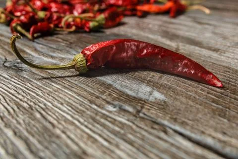 One dried red hot chilli peppers on old wooden table Stock Photos