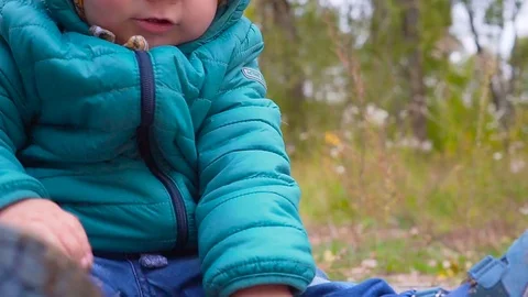 One ear old boy plays in autumn park with dirt, sand. gimbal 스톡 동영상 80977263