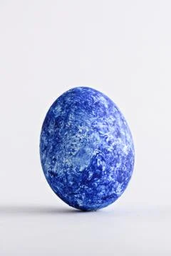 One Easter classic blue egg on white background Stock Photos