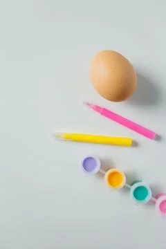One Easter egg with bright colorful paints and markers on white background... Stock Photos
