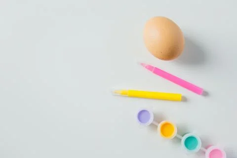 One Easter egg with bright colorful paints and markers on white background .. Stock-Fotos