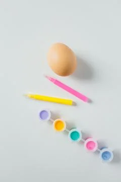 One Easter egg with bright colorful paints and markers on white background... Stock Photos