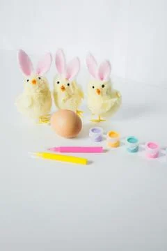 One Easter egg with bright colorful paints, markers and funny small toy chi.. Stock Photos