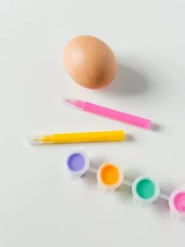 One Easter egg with bright colorful paints and markers on white background... Stock Photos