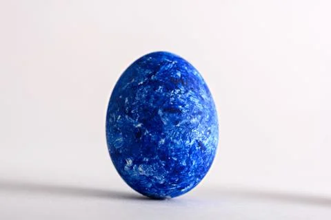 One Easter egg in the color of year-classic blue on white background Stock Photos