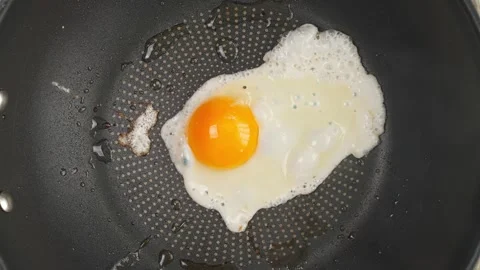 One egg fried in a frying pan top view Stock Footage 261170628