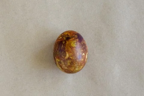One egg, painted in brown colors, on kraft paper. Minimalism concept Stock Photos