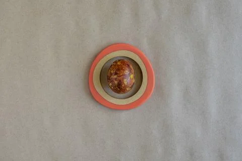 One egg, painted in brown colors, on craft paper background. Minimalism Stock Photos