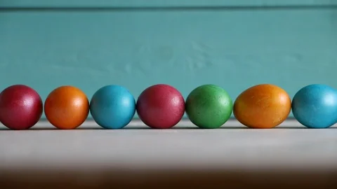 One Egg Rolls on the Background of a Row of Eggs. Easter. Spring Concept Stock Footage 122501975