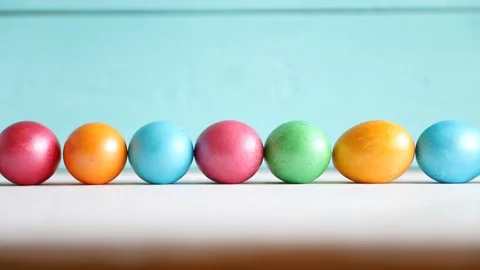 One Egg Rolls on the Background of a Row of Eggs. Easter. Spring Concept Stock Footage 122502005