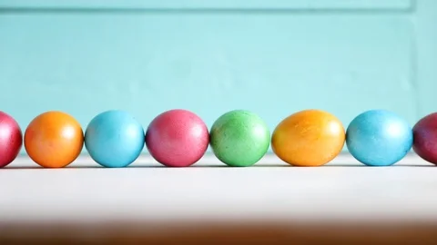 One Egg Rolls on the Background of a Row of Eggs. Easter. Spring Concept Stock Footage 122502093