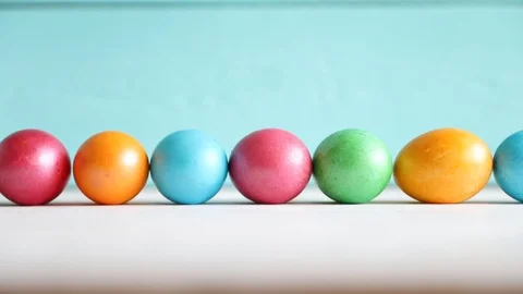 One Egg Rolls on the Background of a Row of Eggs. Easter. Spring Concept Stock Footage 122502258