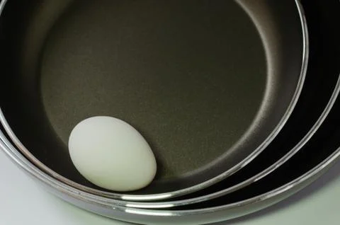One egg in three pans Stock Photos