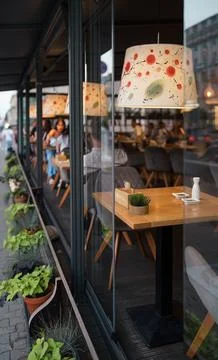 One empty unoccupied table in a cozy catering establishment awaits customers. Stock Photos