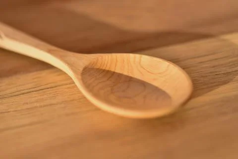 One empty wooden spoon close-up on a wooden cutting board. template for a cul Stock Photos