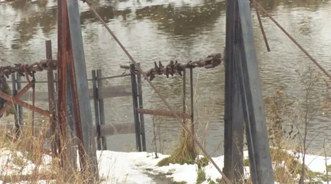 One End of the River Metal Bridge. Winter River Waters Running. Young Country Video stock 65500198