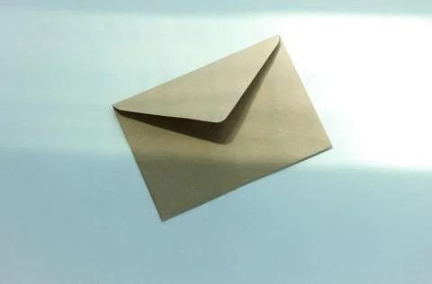 One envelope postal on a white background with highlights from the window Stock Photos