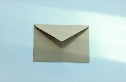 One envelope on a white background with highlights from the window Stock Photos