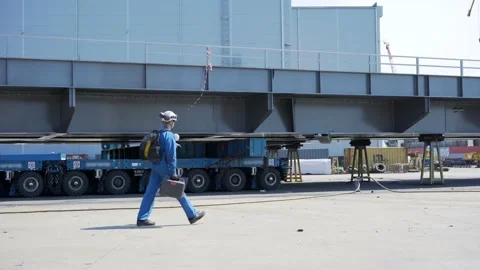 One equipped professional engineer walking at heavy industrial assembly line.  Stock Footage 133397310