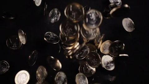 One euro coins fall on a black background Stock Footage 80446633