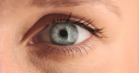 One eye closeup. Blue eye looking at different sides, Stock Footage 76549713