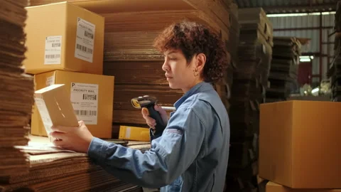 One female worker scan bar codes to check orders at parcels warehouse factory. 스톡 동영상 170685397