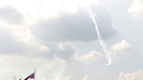 One fighter jets in the blue sky. country flags. A general plan. Aerobatic Stock Footage 124145797