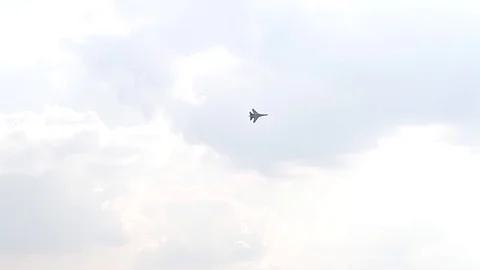 One fighter jets circle in the blue sky. A general plan. Aerobatic figures Stock Footage 124145508