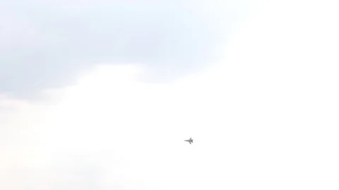 One fighter jets circle in the blue sky. A general plan. Aerobatic figures Stock Footage 124145519