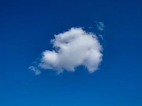 One fluffy cloud in the blue sky Stock Photos