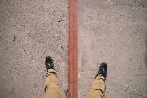One foot on either side of the Equator at the 'Middle of the World', San Antonio Stock Photos