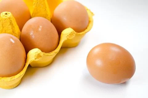 One free range farm egg outside the carton Stock Photos