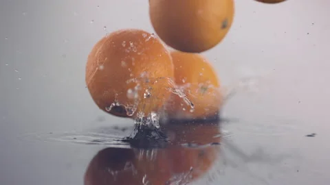 One fresh orange falls down in slow motion, more following Stock Footage 147233840