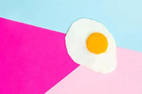 One fried egg on pink background, pop art, isolated from the right side Stock Photos